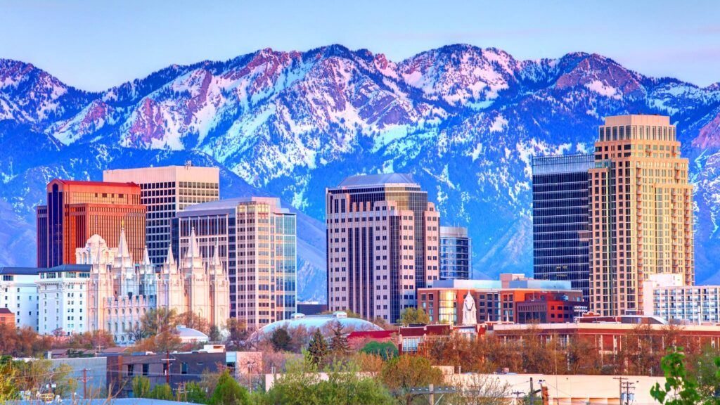 cityscape of salt lake city utah with buildings and snow capped mountains